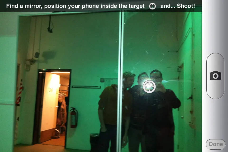 Camera mode: a target over the flash in a mirror shot of three people, with the instruction to find a mirror and shoot