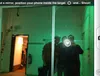 Camera mode: a target over the flash in a mirror shot of three people, with the instruction to find a mirror and shoot