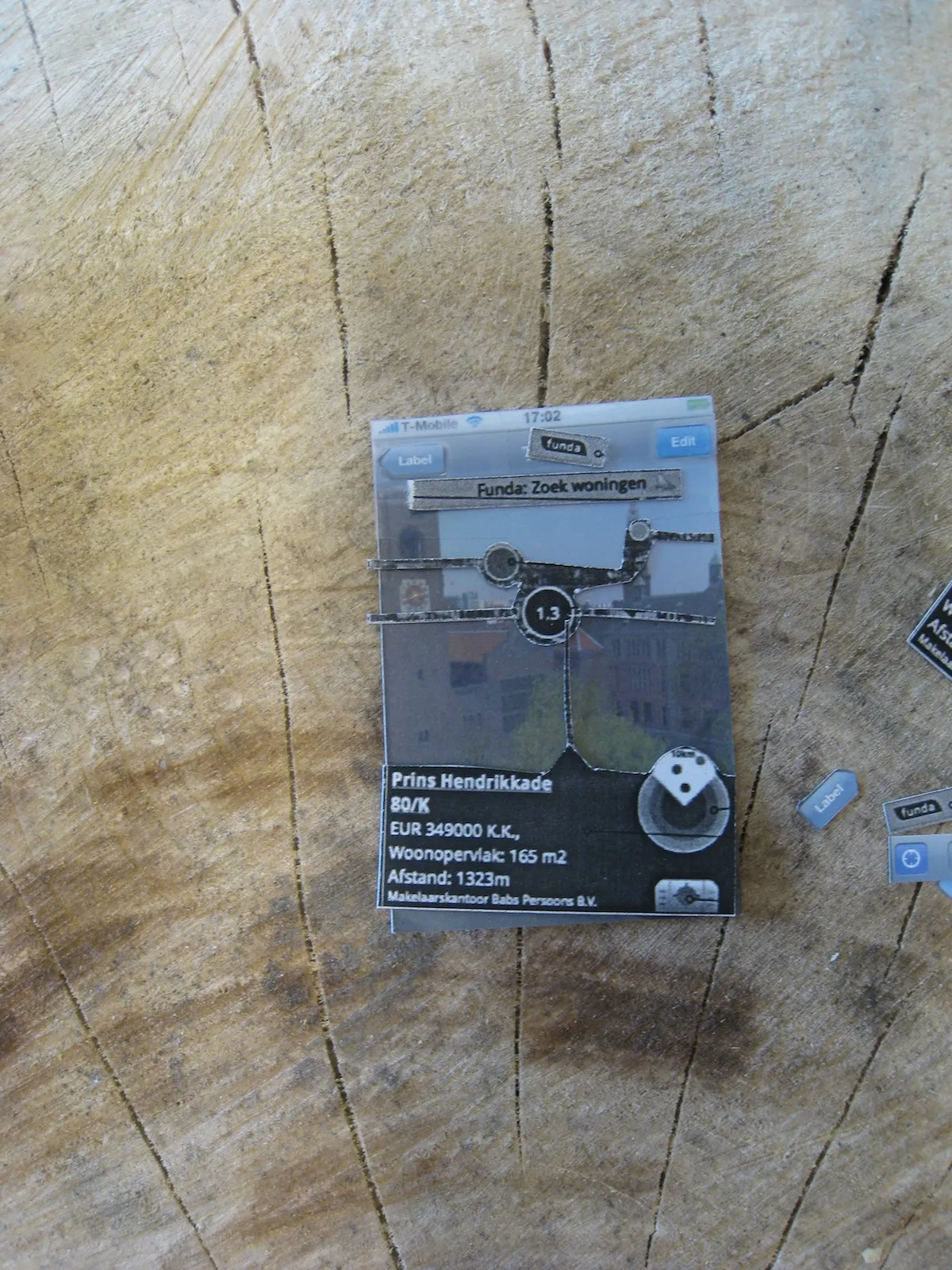 Paper prototype of the AR view: a Funda house listing, distance marker and radar layered as cut-outs over a photo of Amsterdam