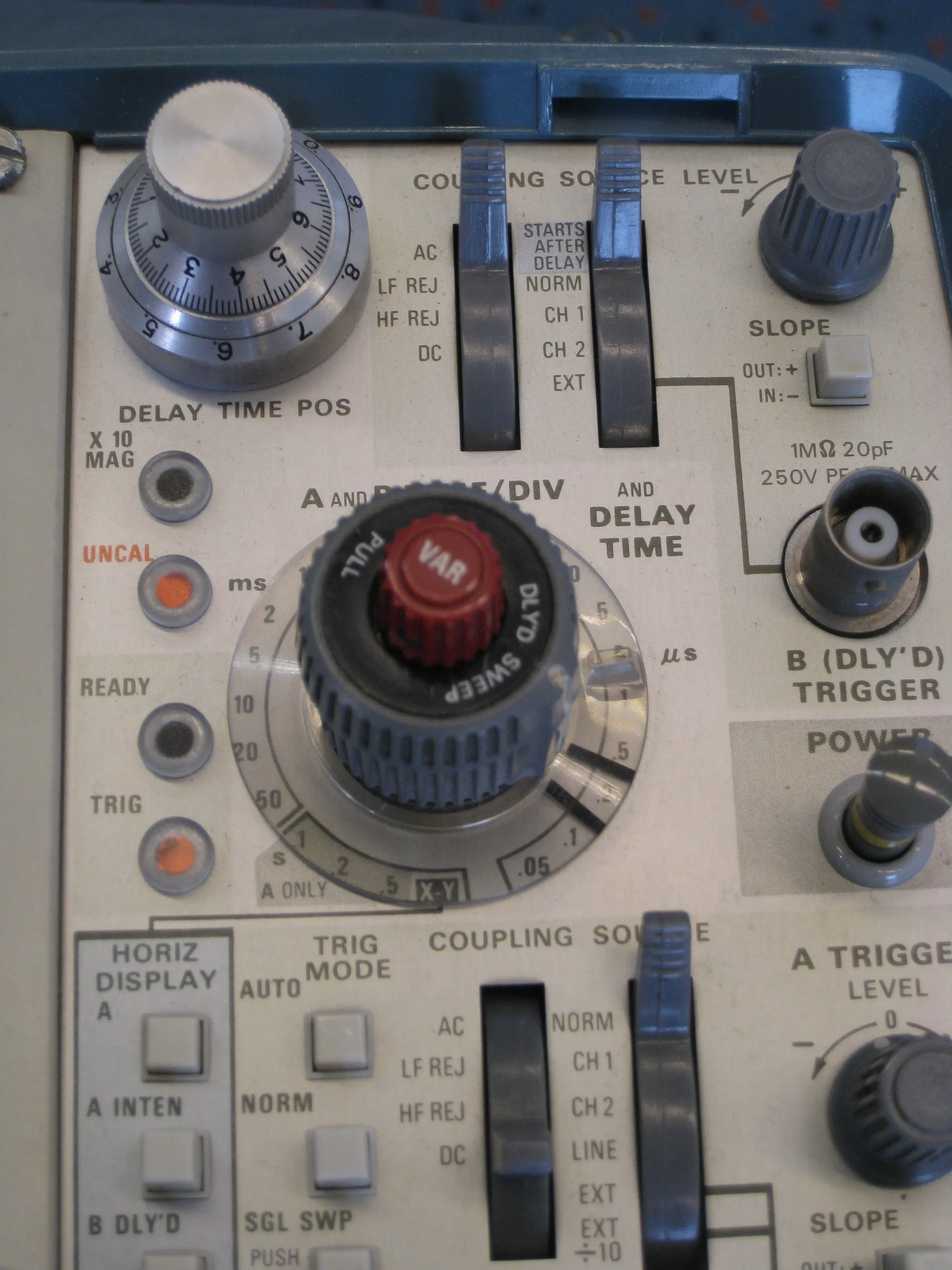 Close-up of the knobs and switches of an old analogue oscilloscope