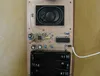 The finished plant-stick board, with a small speaker, a volume knob, the amplifier chips and a four-battery holder above its pointed tip