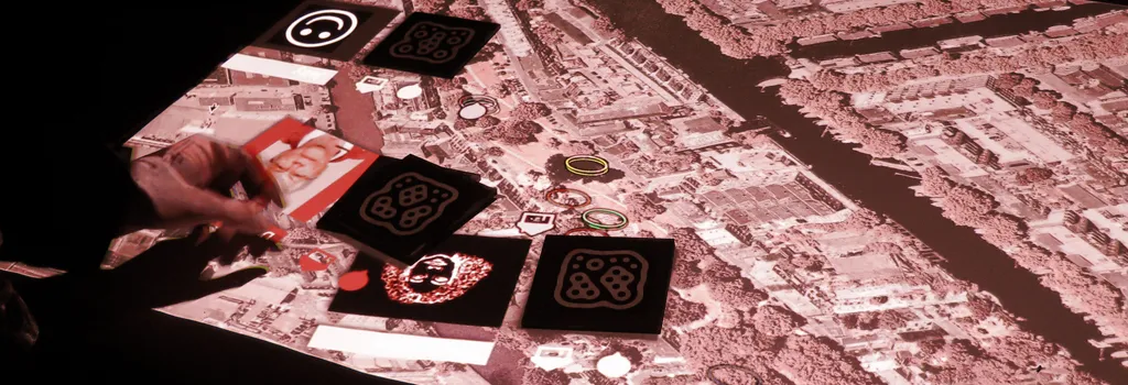 A hand interacting with a tangible object on the Tableviewer surface
