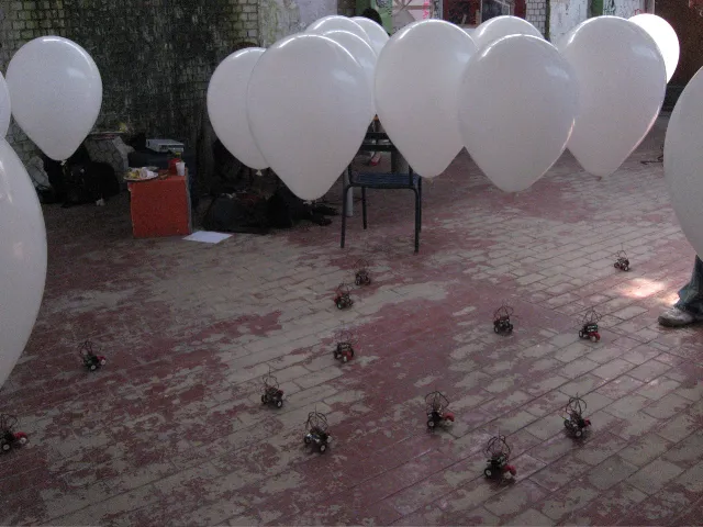 The flock spread out over a worn brick floor, the first balloons floating above them